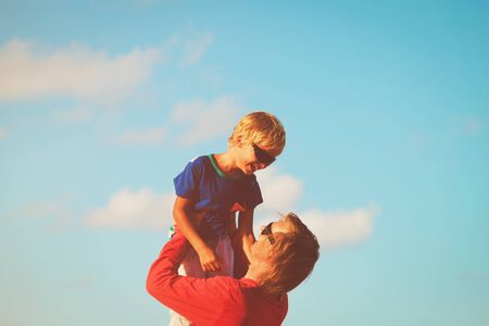 happy father and little son playing on skyの写真素材