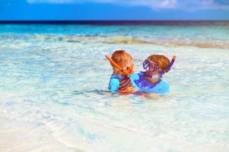 happy mother and son snorkeling on beachの写真素材