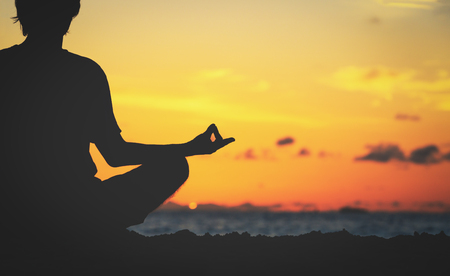 serenity and yoga practicing at sunsetの写真素材