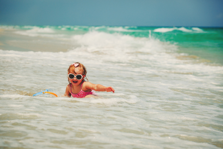 ittle girl play with water at beachの写真素材