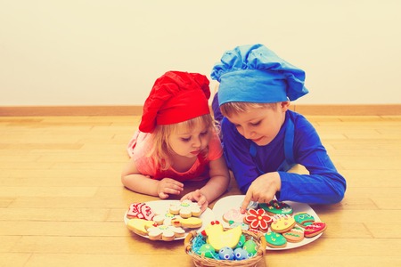 little boy and girl making easter cookiesの写真素材