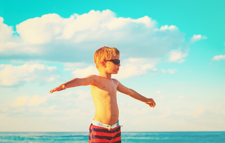 little boy having fun on tropical beachの写真素材