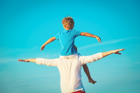 father and son having fun on skyの写真素材