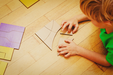 little boy playing with puzzle, education and learningの写真素材