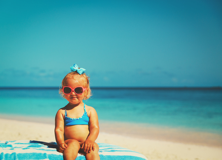 father and cute little daughter loving hug at beachの写真素材