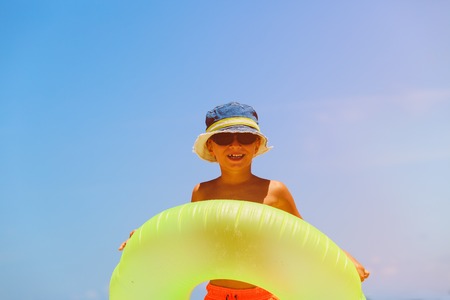 happy little boy play at summer beachの写真素材