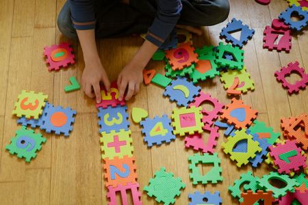 little boy playing with puzzle, education