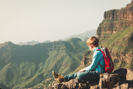 little boy travel hiking in mountainsの写真素材