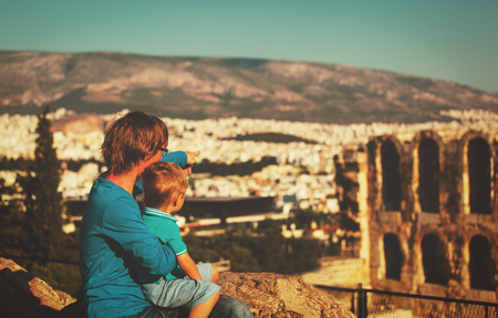 father and son looking at the city of Athens, Greece from Acropolisの写真素材