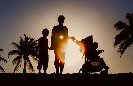 family with two kids on sunset beachの写真素材
