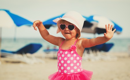cute little girl play at summer beachの写真素材