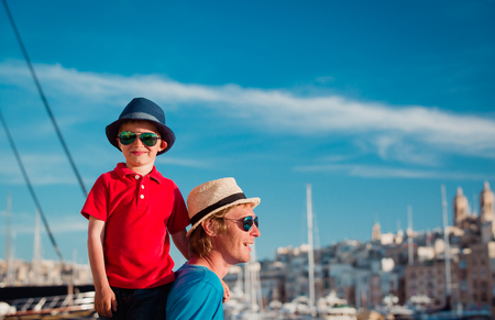 family travel - father and son playing on the quay of Maltaの写真素材
