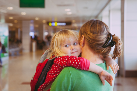 mother and little daughter waiting in airportの写真素材