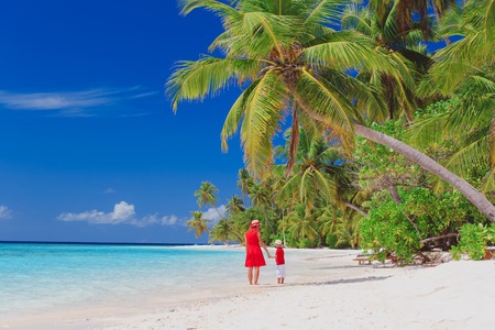 mother and son walking on beachの写真素材