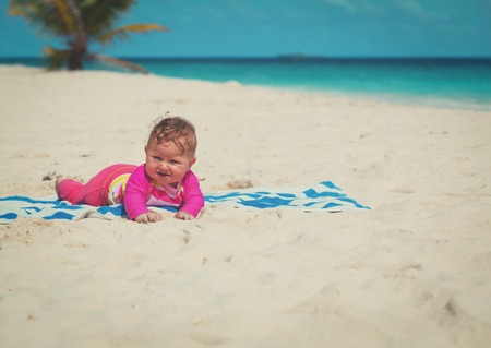 cute baby girl on tropical beachの写真素材