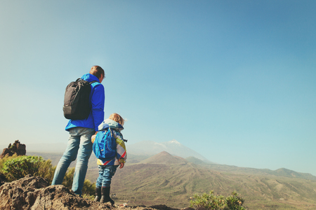 father and little daughter hiking in mountainsの写真素材