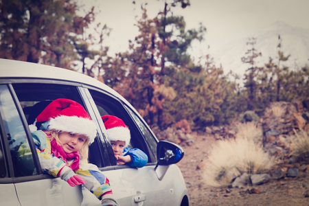 christmas car travel- happy kids travel in mountainsの写真素材