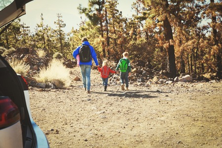 father with kids travel by car in mountainsの写真素材