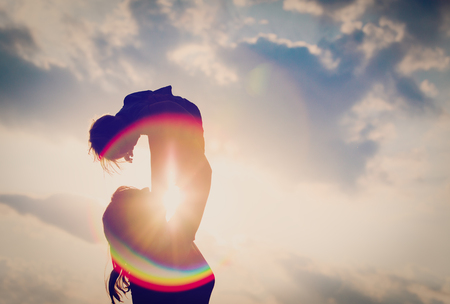 mother and little baby play at sunsetの写真素材