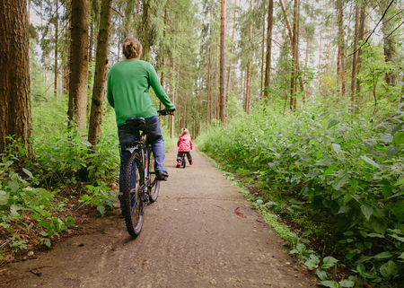 mother and little daughter riding bikes in nature, active familyの写真素材