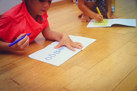 kids write numbers, draw, do homework