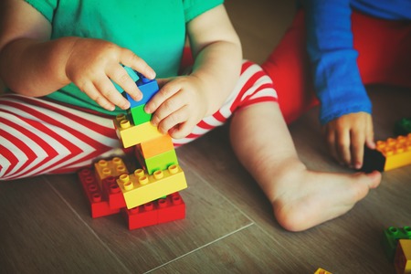 kids playing with colorful plastic blocksの写真素材