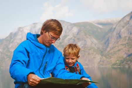 father and son travel hiking in mountains of Norwayの写真素材