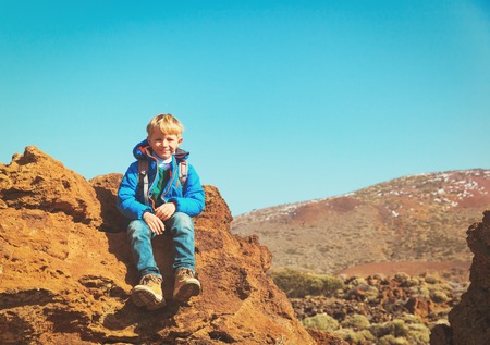 happy little boy enjoy hiking in mountainsの写真素材