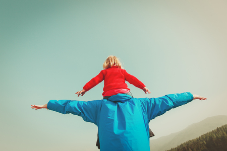Father and little daughter play at skyの写真素材