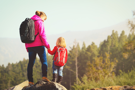 family travel- mother and daughter hiking in mountainsの写真素材