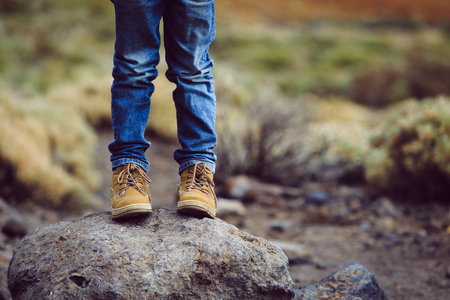 travel concept - little boy hiking boots in mountainsの写真素材