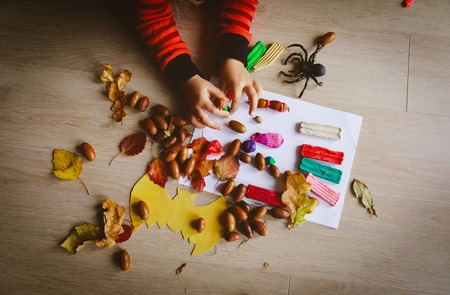 Halloween preparation. Little girl making crafts from clay and natural materialsの写真素材