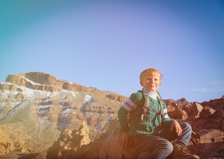 travel concept - little boy enjoy hiking in mountainsの写真素材