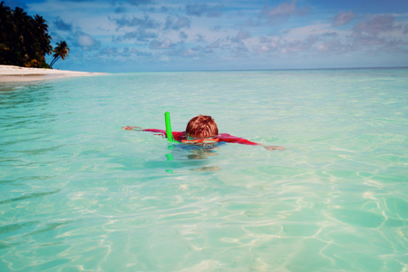 little boy swimming with mask at seaの写真素材
