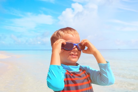 little boy get ready to swim at tropical beachの写真素材