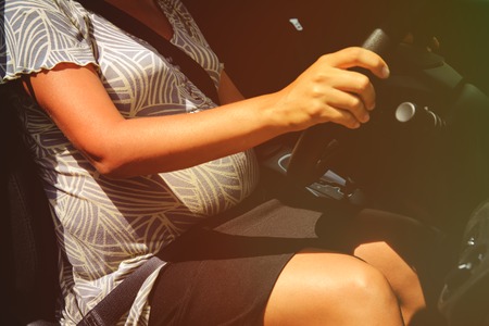 pregnant woman driving a car