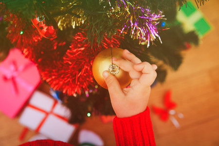 child decorating Christmas treeの写真素材