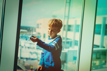 boy play with toy plane while waiting in airportの写真素材