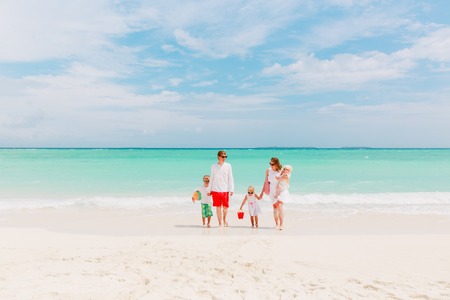 happy family with three kids walk on beachの写真素材