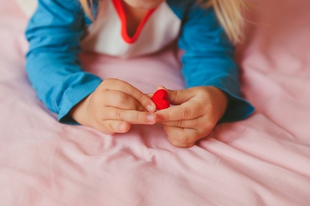 Love and family. little girl holding heart in handsの写真素材
