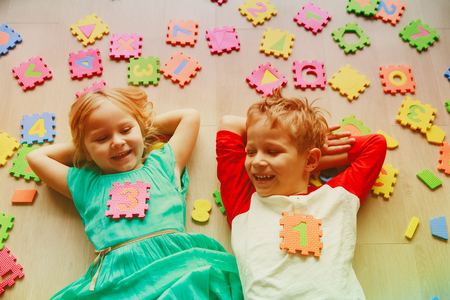 happy little girl and boy learn numbers and shapesの写真素材