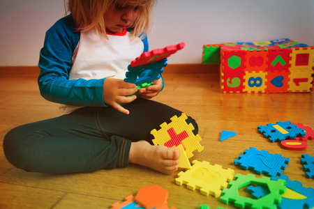 little girl playing with puzzle, educationの写真素材