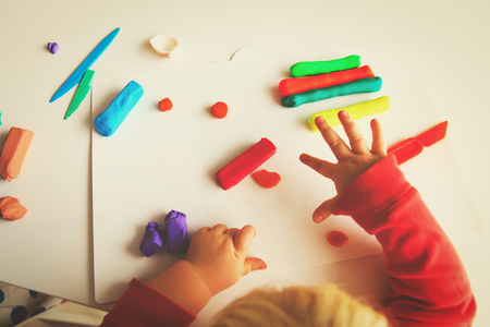 little baby play with clay molding shapesの写真素材