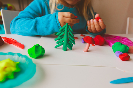 Child playing with clay molding shapesの写真素材