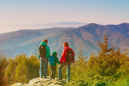 family with little child hiking in mountainsの写真素材