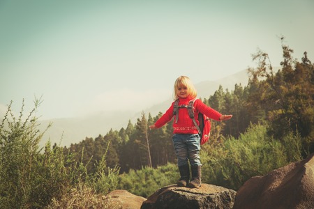 little girl hiking in mountains, family travelの写真素材