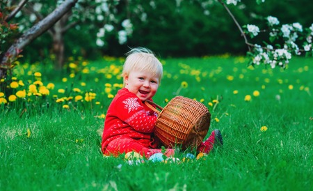 cute happy little girl on easter eggs hunt in springの写真素材