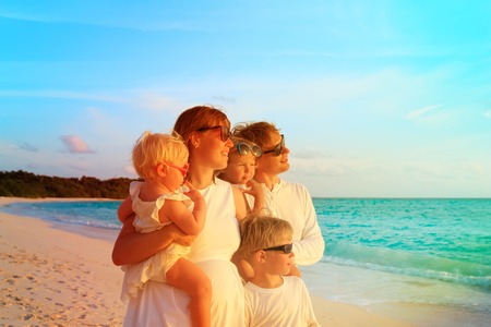 happy family with three kids on tropical beachの写真素材