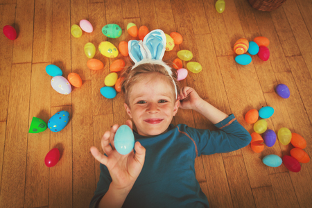 happy little boy play with easter eggs