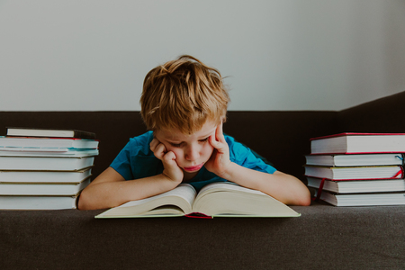 little boy tired stressed of reading, doing homeworkの写真素材